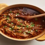 Birria Recipe: 7 Authentic Steps for the Best Juicy Tacos Shredded birria beef on a wooden board